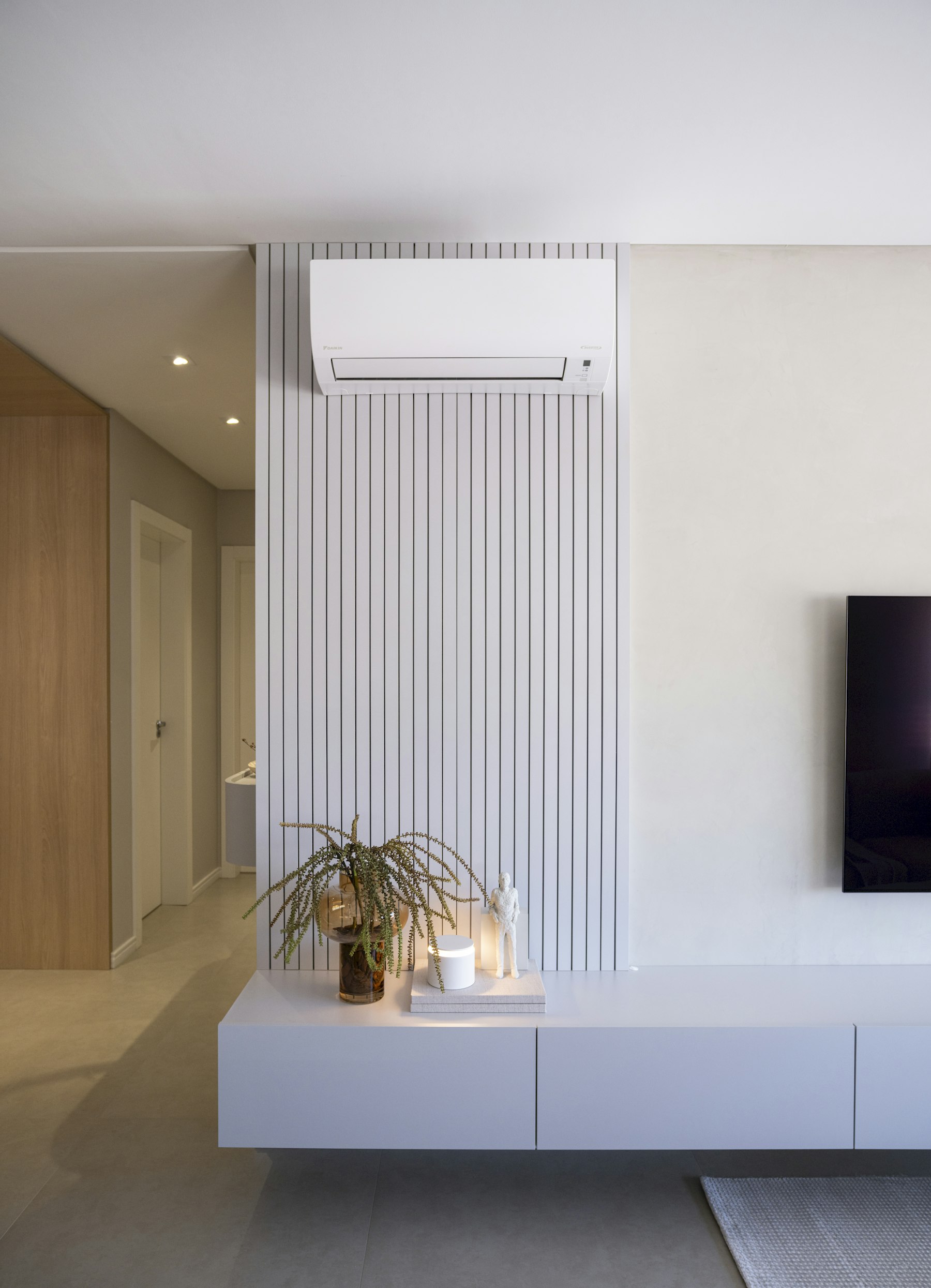Minimal living room wall with a fitted split air conditioning unit